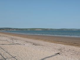 A beach with sand and water at Ocean Breeze in Weymouth