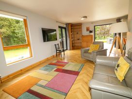 A living room with a sofa and tv at 3 bed property 