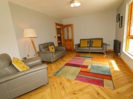 A living room with two sofas and a rug at 3 bed property
