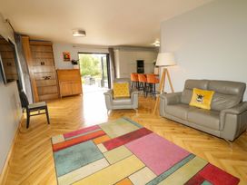 A living room with a sofa and an armchair at 3 bed property