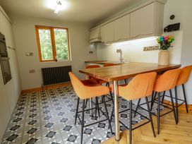 A kitchen with a table and chairs at a 3 bed property