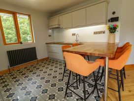A kitchen with a table and chairs at 3 bed property