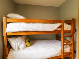 A bunk bed with pillows and a smiley face pillow in a bedroom