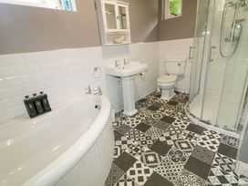 A bathroom with a bathtub, sink, shower, and toilet