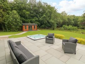 A garden with seating and a hot tub at a 3 bed property