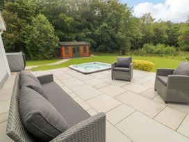 An outdoor area with furniture and a hot tub at 3 bed property 