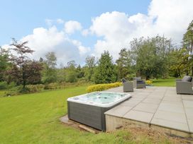 A garden with a hot tub and chairs at a 3 bed property