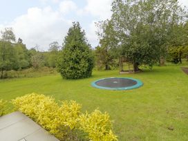 A garden with a trampoline and play structure at 3 bed property