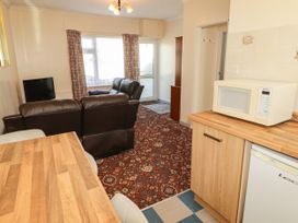 A living room with a sofa and television at Cottage 1 in Tenby