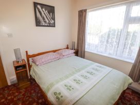 A bedroom with a bed and bedside table at Cottage 1 in Tenby