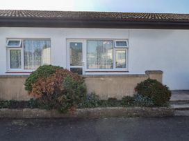 A house with windows and a door at Cottage 3 in Tenby