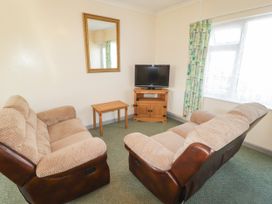 A living room with sofa and television at Cottage 3 in Tenby