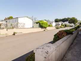 A street with mobile homes and greenery at Cottage 3 in Tenby