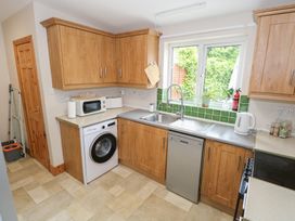 A kitchen with appliances and green tiles at Ti Maolla in Hollymount