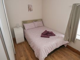 A bedroom with a double bed and a nightstand at Ti Maolla in Hollymount