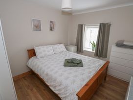 A bedroom with a bed and dresser at Ti Maolla in Hollymount