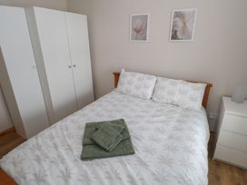 A bedroom with a bed and wardrobe at Ti Maolla in Hollymount