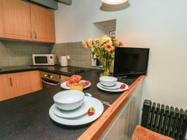 A kitchen with a microwave and a bowl on the counter at The Snug Glaisdale