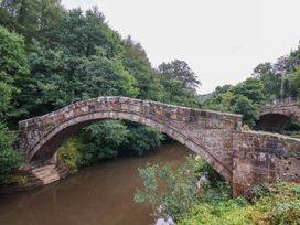 A bridge over a river with trees surrounding at The Snug Glaisdale Glaisdale