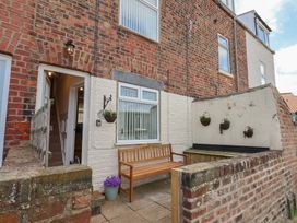 A bench in front of a brick wall at 4 Studley Terrace Whitby