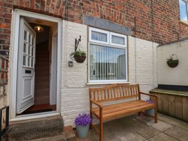 An entrance with a bench and stairs at 4 Studley Terrace in Whitby