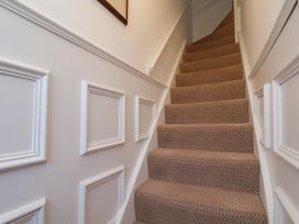 A staircase with carpet and wall features at 4 Studley Terrace Whitby