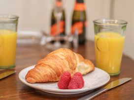 A croissant and raspberries with orange juice on a table at 4 Studley Terrace, Whitby