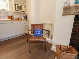 A kitchen with an armchair and a radiator at 4 Studley Terrace Whitby