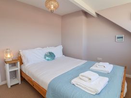 A bedroom with a bed and lantern at 4 Studley Terrace Whitby