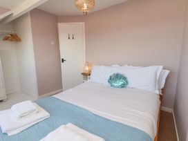 A bedroom with a bed and lantern at 4 Studley Terrace in Whitby