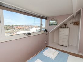 A bedroom with a window and dresser at 4 Studley Terrace in Whitby