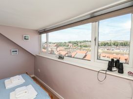 A bedroom with a bed and binoculars at 4 Studley Terrace in Whitby