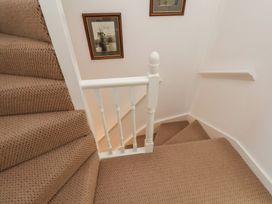 A staircase with carpet and pictures on the wall at 4 Studley Terrace in Whitby