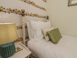 A bedroom with a bed and lamp at 4 Studley Terrace in Whitby
