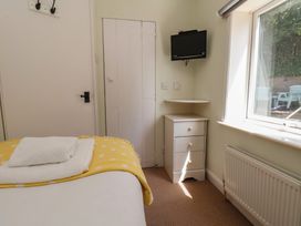 A bedroom with a bed and a television at 4 Studley Terrace in Whitby