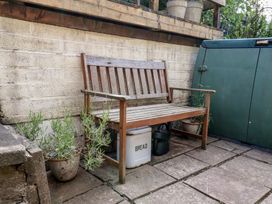 A garden with a wooden bench and planters at 4 Studley Terrace in Whitby