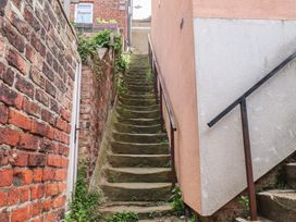 Stairs leading up with brick wall and handrail at 4 Studley Terrace Whitby