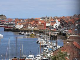 A view of a harbor with boats and buildings at 4 Studley Terrace Whitby