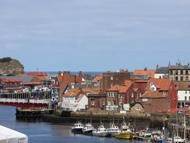 A view of boats and houses at the harbor at 4 Studley Terrace in Whitby
