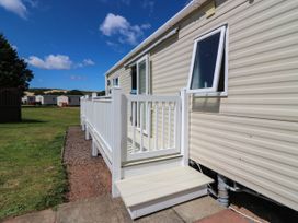 A deck with steps leading to a side of a house at Rowan View 251