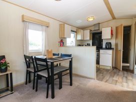 A dining area with table and chairs at Rowan View 251 