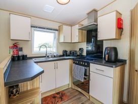 A kitchen with appliances and a window at Rowan View 251