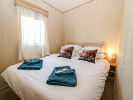 A bedroom with a double bed and window at Rowan View 251