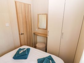 A bedroom with a bed and wardrobe at Rowan View 251