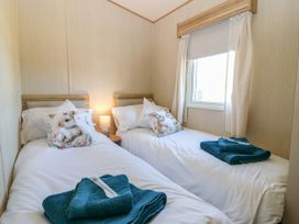 A bedroom with two beds and a window at Rowan View 251