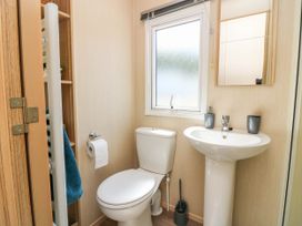 A bathroom with a toilet and sink at Rowan View 251 