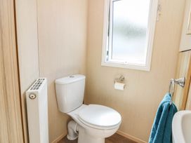 A bathroom with a toilet and window at Rowan View 251