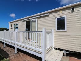 A mobile home with a deck and railing at Rowan View 251