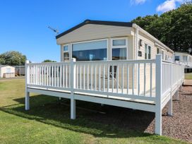 A mobile home with a decking area at Rowan View 251