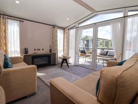 A living room with a sofa and coffee table at Lodge - Plot 18 near Sherburn